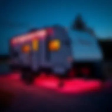 A travel trailer showcasing vibrant underbody lights illuminating the surroundings.